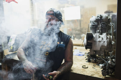 A man leaning and smoking.