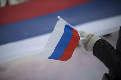 Flag of russia in hand. symbol of state of russian federation. national flag.