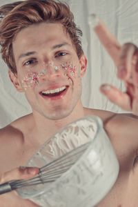 Portrait of shirtless man smiling