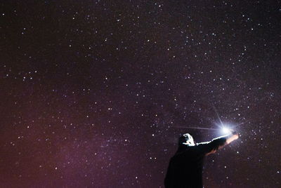 Man against sky at night