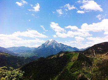 Scenic view of mountains against cloudy sky