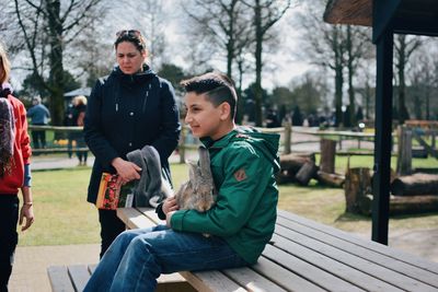 Men sitting on bench in winter