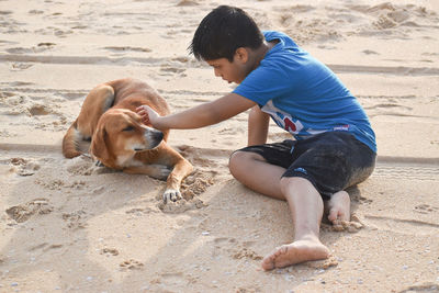 Boy and dog on beach
