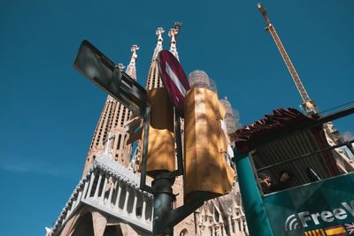 Low angle view of flags on building against sky