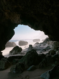 Scenic view of sea seen through cave