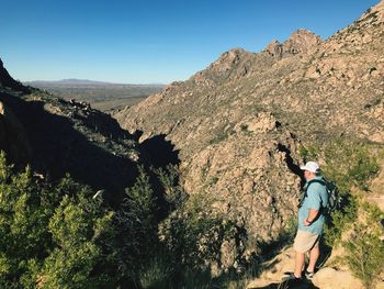 High angle view of man standing against mountains