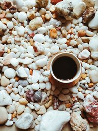 High angle view of coffee on pebbles
