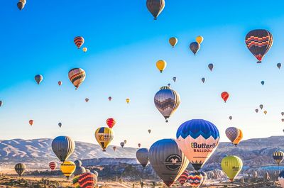 Multi colored hot air balloons flying in sky