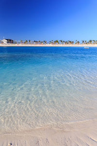 Scenic view of sea against clear blue sky