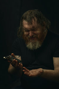Portrait of senior man playing guitar