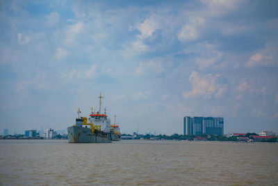 Commercial dock by sea against sky