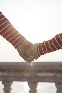 Close-up of hands against clear sky