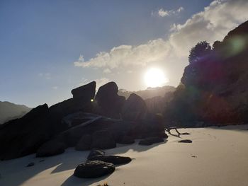 Rocks on beach against sky