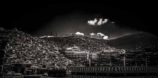 Low angle view of illuminated cityscape against sky at night