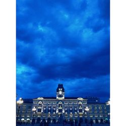 Low angle view of buildings against cloudy sky