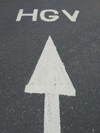 High angle view of arrow sign on street