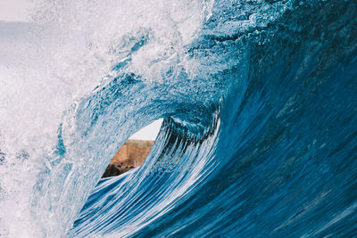 Close-up of sea waves splashing against sky