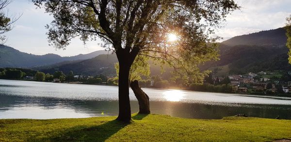 Scenic view of lake by mountains against sky