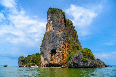 Rock formations in sea against sky