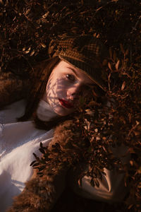Close-up of young woman in forest during autumn