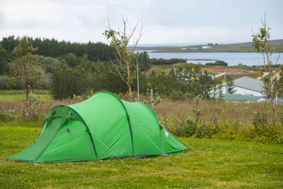 Scenic view of tent on field against sky