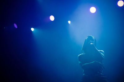 Full length of woman enjoying at music concert