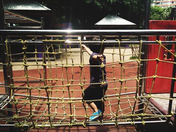 Girl playing on tightrope in playground