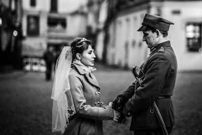 Side view of couple standing outdoors