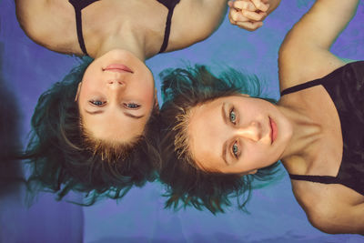 High angle portrait of happy girl lying on swimming pool