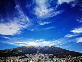 Scenic view of mountains against blue sky