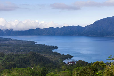 Scenic view of sea and mountains against sky