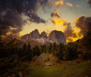 Scenic view of rocky mountains against sky during sunset