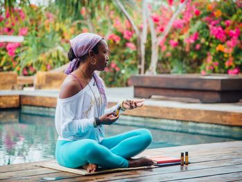 Side view of woman sitting in swimming pool