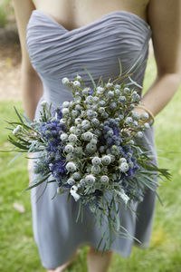 Midsection of woman holding bouquet