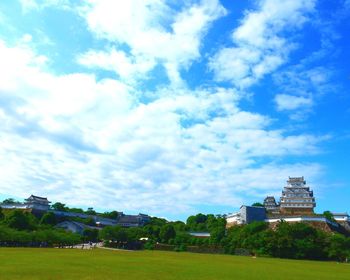 Buildings against cloudy sky