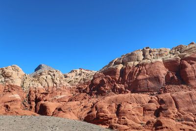 Rock formations against clear blue sky