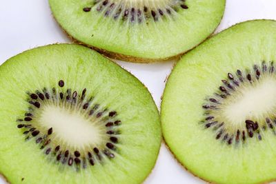 Close-up of kiwi slices on white background