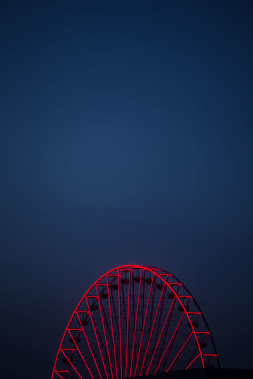 LOW ANGLE VIEW OF ILLUMINATED FERRIS WHEEL AGAINST SKY AT NIGHT