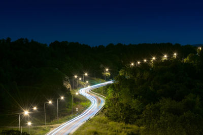 High angle view of light trails on road at night