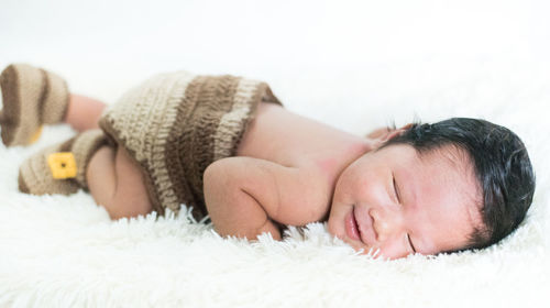Midsection of woman sleeping on bed