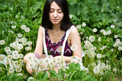 Beautiful woman by flowering plants