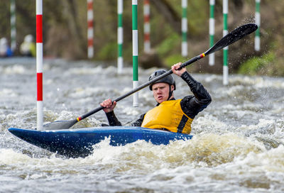 Man kayaking in river