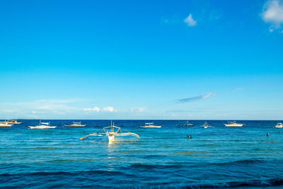 Boats in sea against sky