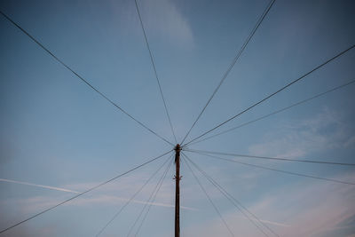 Low angle view of electricity pylon against sky