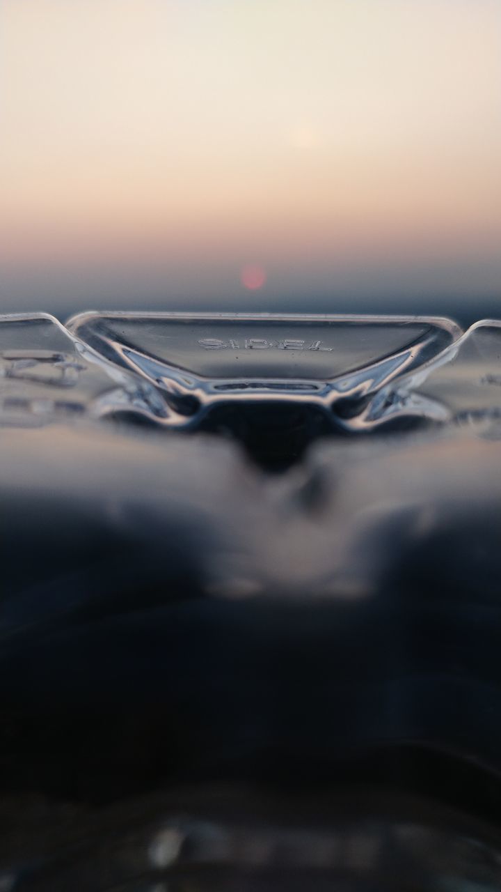 CLOSE-UP OF CAR WINDSHIELD AGAINST SKY