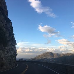 Empty road with mountain range in background