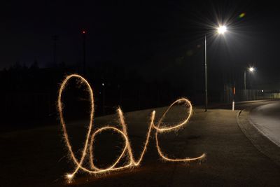 Illuminated light painting on street at night