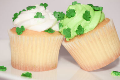 Close-up of cup cakes over white background