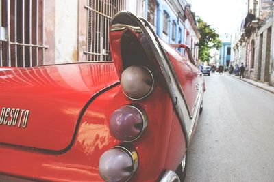 Close-up of red car on street