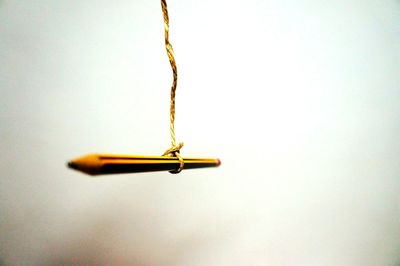 Close-up of yellow pencils on table against white background